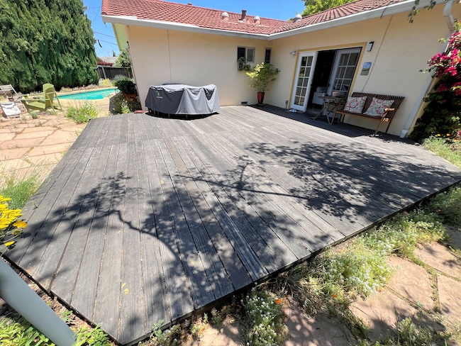 Severely weathered gray redwood deck in Cupertino before cleaning and refinishing