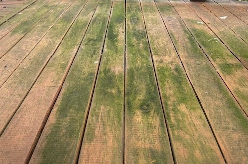 Weathered exterior wood deck before professional sanding and staining