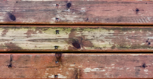 Weathered exterior wood deck before professional sanding and staining