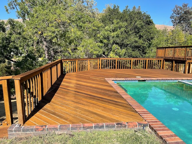 Restored redwood pool deck after professional cleaning, refinishing, and staining in Fremont.