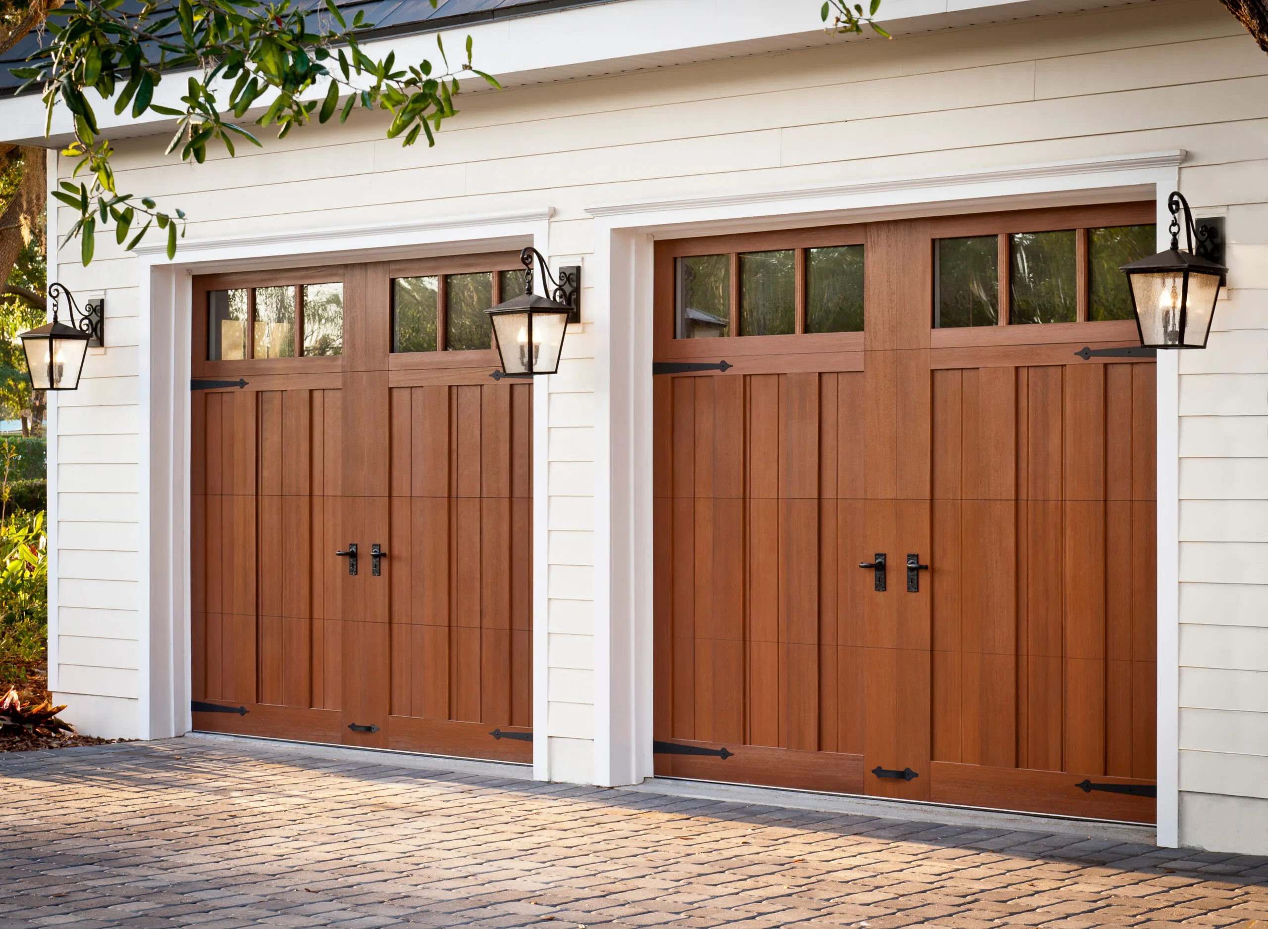 Wood garage door before and after professional refinishing and restoration.