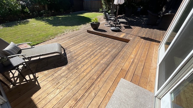 redwood deck before refinishing in Los Altos showing weathered boards and a faded protective finish.