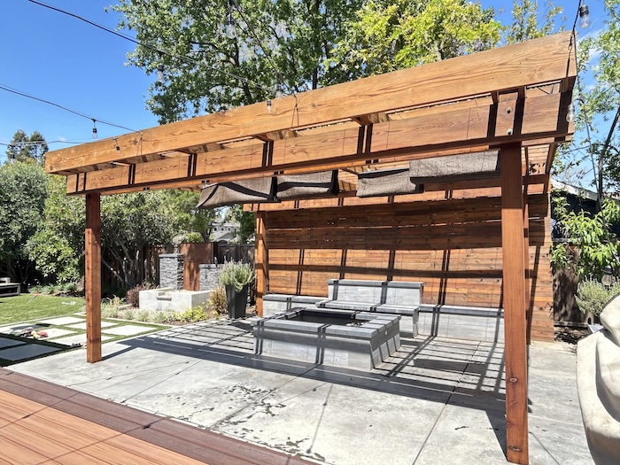 Redwood pergola and wood wall in Los Gatos after professional refinishing and staining