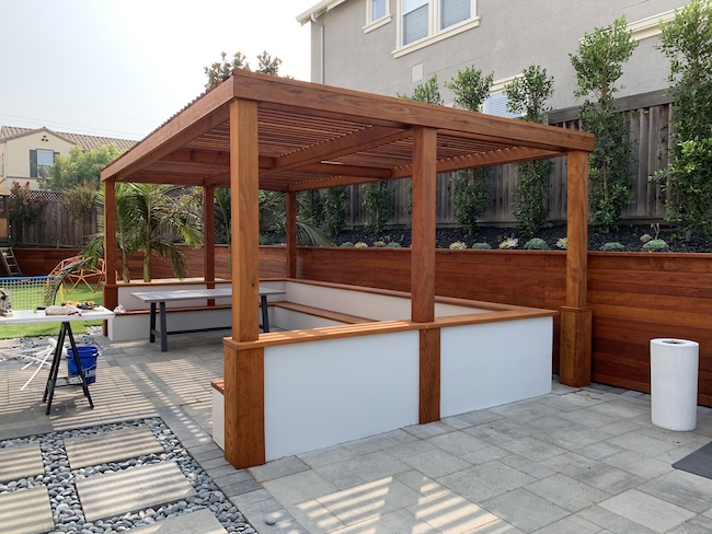 Newly sealed redwood pergola and retaining wall with a natural finish in San Jose, CA.