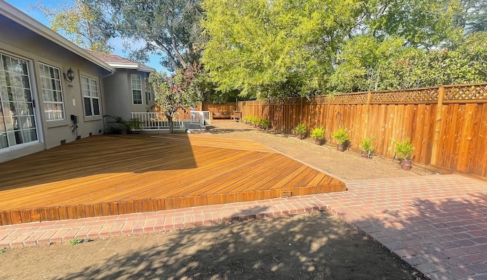 Saratoga wood deck and fence after professional sanding and cedar-toned staining
