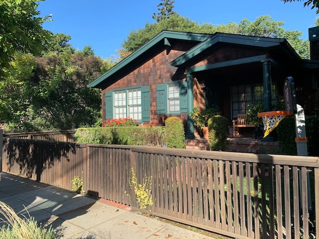 Weathered cedar shingle siding before professional refinishing and staining in Palo Alto, CA.