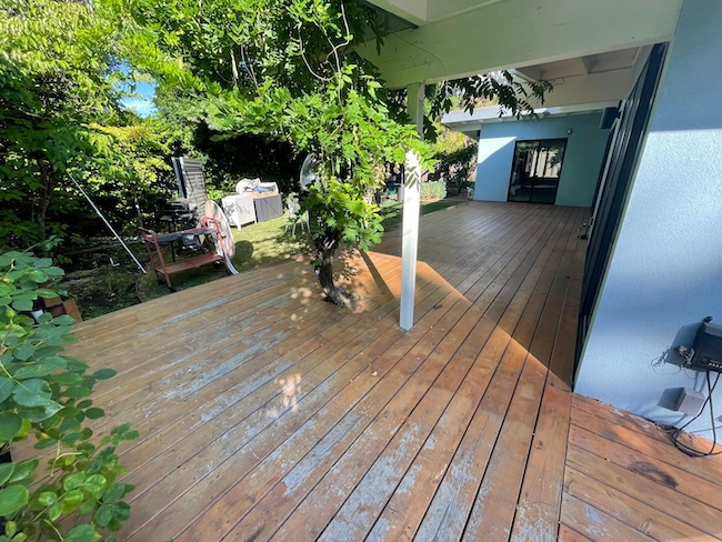 Weathered cedar deck before refinishing at a home in Palo Alto with faded wood and worn protective finish.