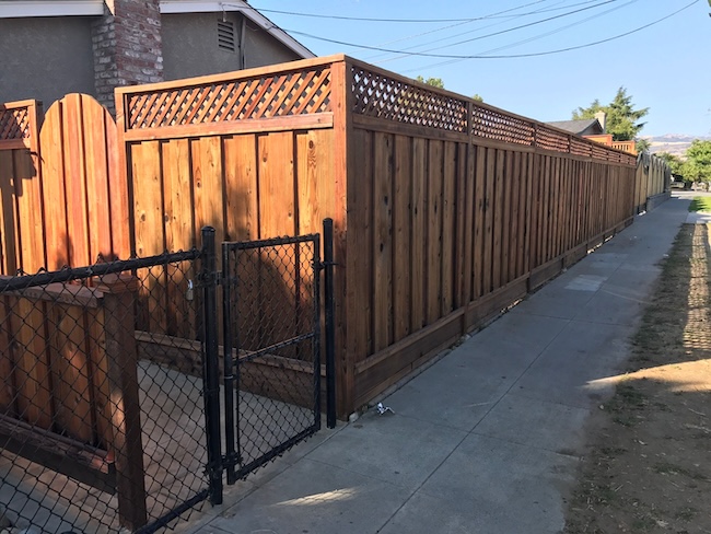 Redwood fence after restoration in San Jose, California with restored natural wood color and protective natural tone stain