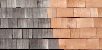 Wood siding restoration showing cleaned and sealed exterior shingles
