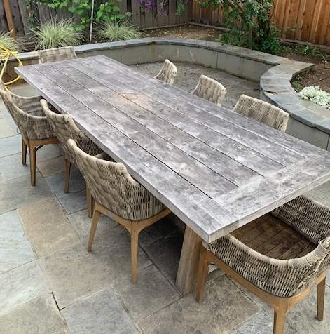Weathered gray teak dining table and chairs before restoration in Los Gatos