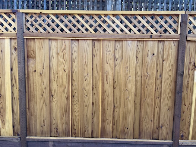 Newly installed wood fence after professional sealing and staining in the San Francisco Bay Area