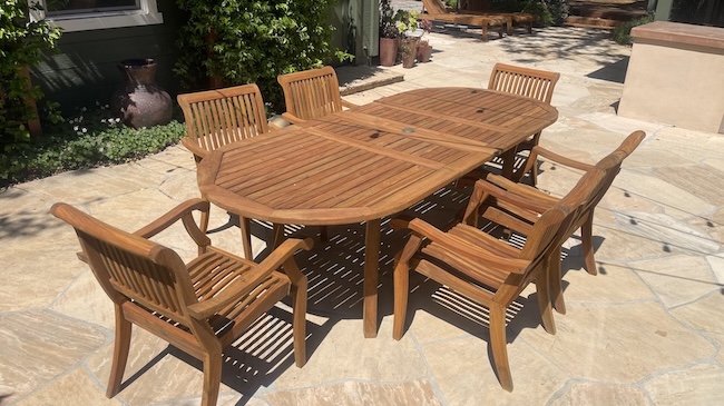Restored teak dining table and chairs after professional refinishing in Palo Alto