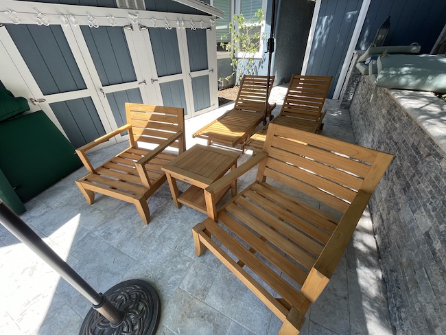 Restored teak chairs and loungers after professional refinishing in San Jose
