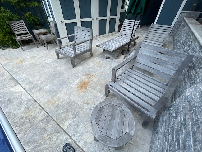 Weathered gray teak chairs and loungers before refinishing in San Jose