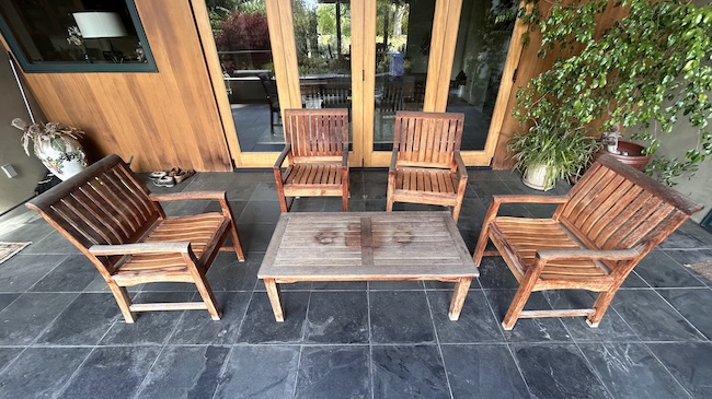 Weathered teak patio seating set before restoration in San Mateo