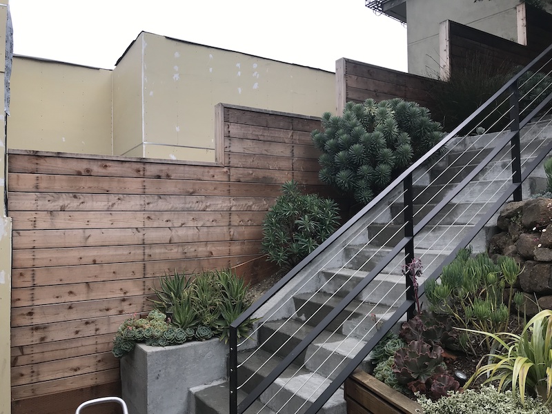Weathered horizontal wood fence in San Francisco before professional refinishing