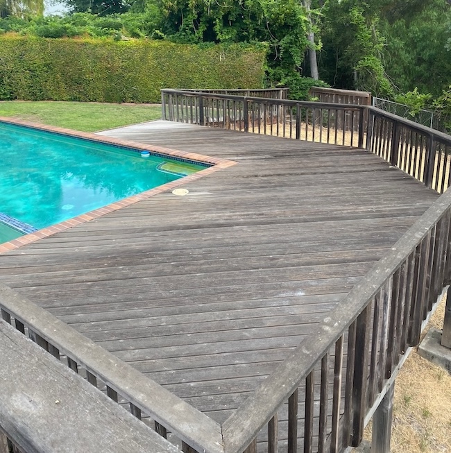 Weathered poolside wood deck in Fremont before professional sanding and refinishing
