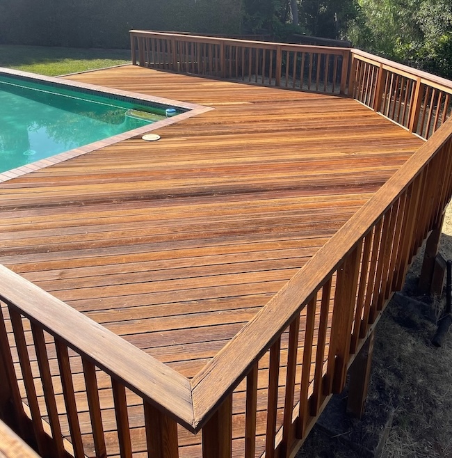 Restored poolside wood deck in Fremont after professional staining and refinishing